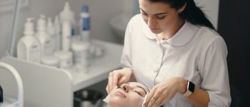 female-cosmetologist-making-facial-treatment-beautiful-woma-1536x1024